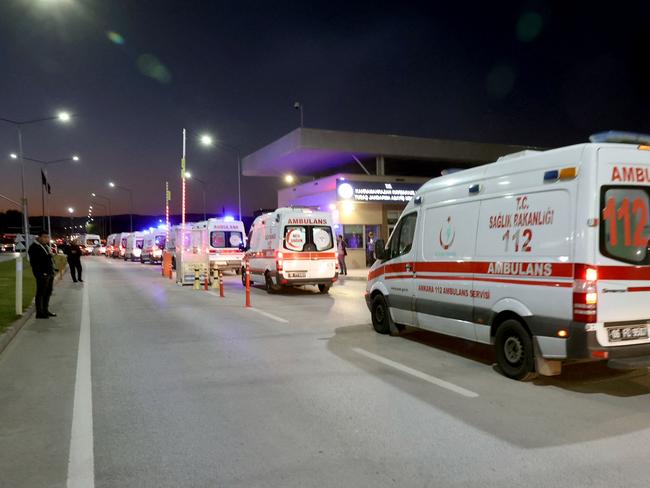 Ambulances line the road leading to the facility. Picture: AFP.