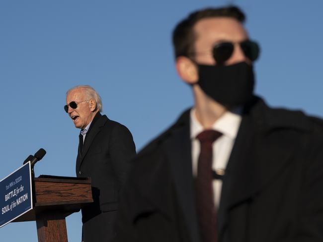 A Secret Service agent stands watch as Democratic presidential nominee Joe Biden speaks at a campaign rally. Picture: AFP