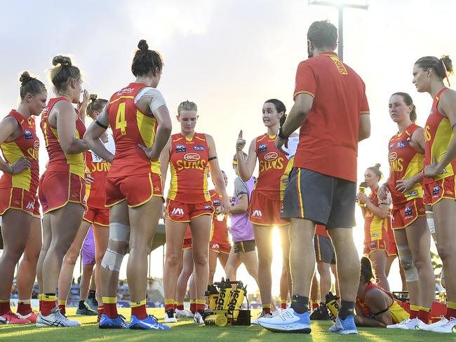 The Suns gather in a huddle at a quarter break during the round one AFLW match between the Gold Coast Suns and the Greater Western Sydney Giants at the Great Barrier Reef Arena on January 09, 2022 in Mackay, Australia. Picture: Ian Hitchcock