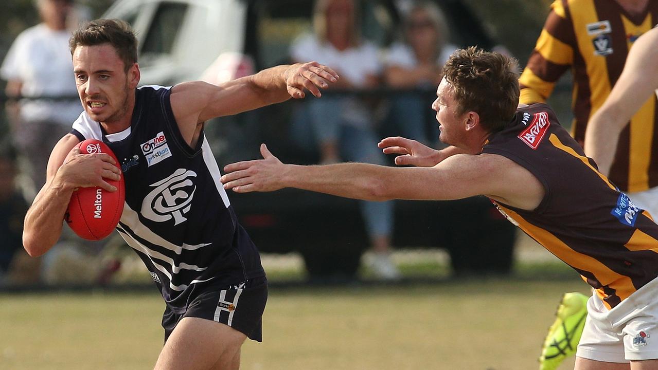 RDFL: Izayha Speer of Melton Centrals runs away from Woodend-Hesket’s Dean Bramley. Picture: Hamish Blair