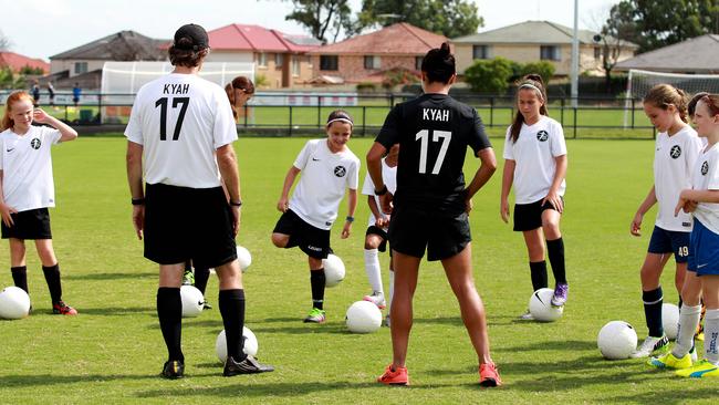 Kyah Simon talking to some of the girls. Picture: Carmela Roche