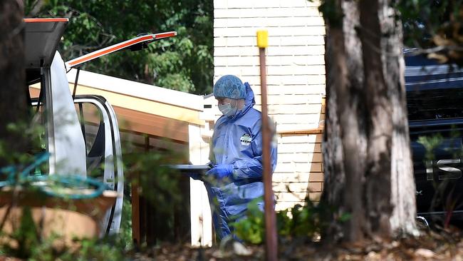 A police forensic officer tends to the scene of the alleged double murder of Frank and Loris Puglia in Joyner. Picture: AAP/Dan Peled