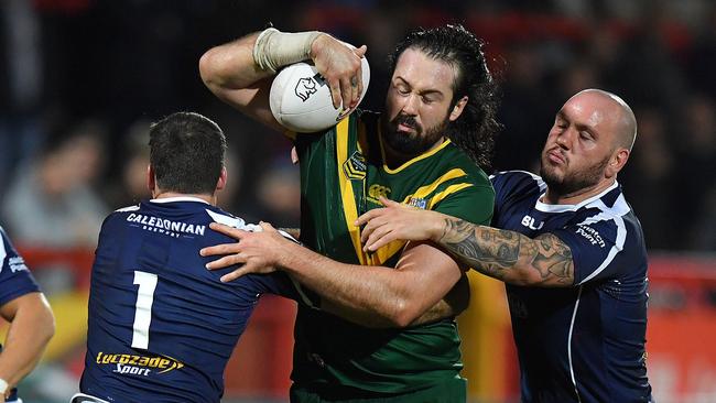 Australia's Aaron Woods is tackled by Scotland's Lachlan Coote and Dale Ferguson during the Four Nations rugby league match Scotland versus Australia at the KC Lightstream Stadium, Hull, England, Friday Oct. 28, 2016. (Dave Howarth/PA via AP)