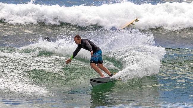 The Queensland State Government Minister of Sport and Housing is a keen surfer when he gets the time. Picture: Surfing Qld