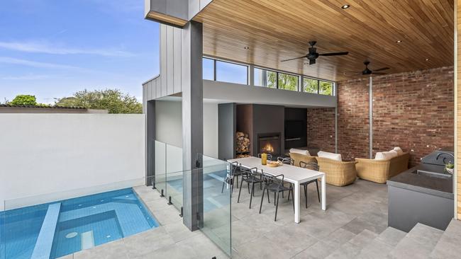 The backyard pool and lavish outdoor entertainment area is a highlight of the home.