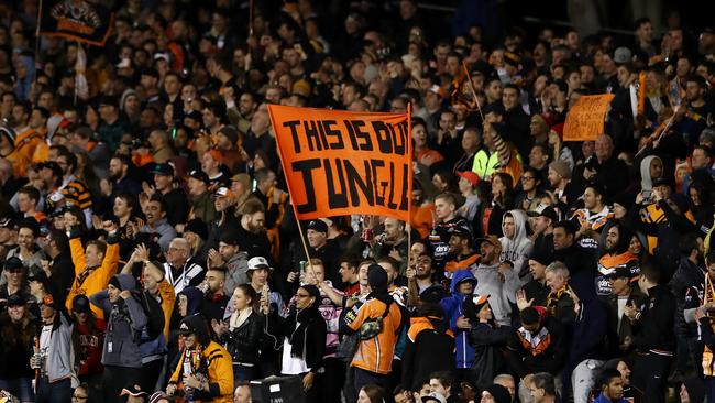 Wests Tigers fans celebrate a try during the Round 10 NRL match against the North Queensland Cowboys at Leichhardt Oval.