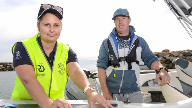 SARDI research officer Dr Crystal Beckmann with recreational fisherman Michael Peace and his squid catch at West Beach boat ramp, Thursday, May 20, 2021. Picture: Brenton Edwards