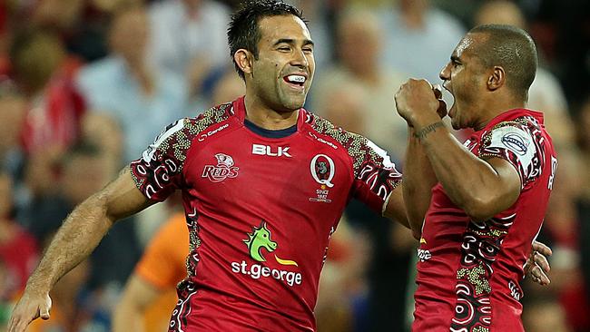 Rod Davies celebrates a try with Reds teammate Will Genia.