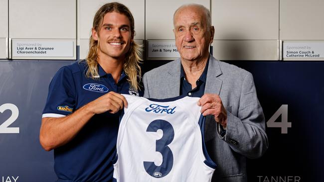 GEELONG, AUSTRALIA - DECEMBER 06: Fred Wooller, the Cats 1963 Premiership Captain poses for a photo with new recruit Bailey Smith and presents him with his number #3 jumper which Bailey will wear in the 2025 season during a Geelong Cats Media Opportunity at GMHBA Stadium on December 06, 2024 in Geelong, Australia. (Photo by Dylan Burns/AFL Photos)