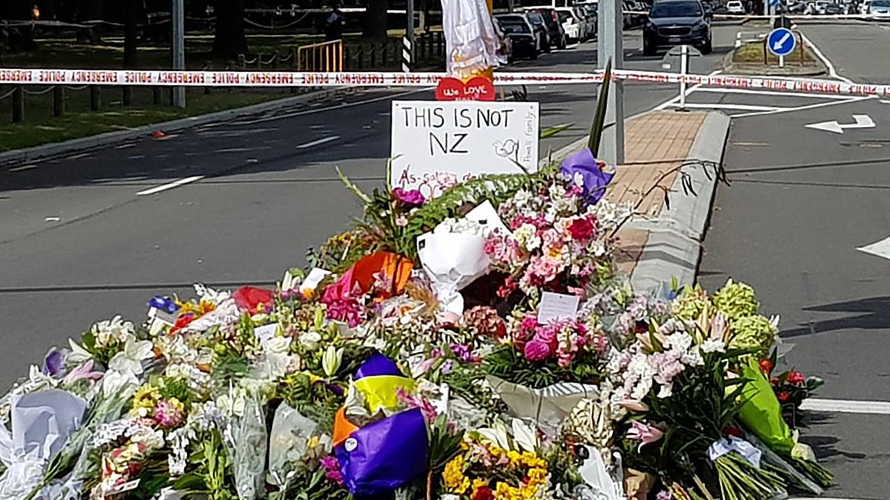 Residents pay their respects by placing flowers for the victims of the mosques attacks in Christchurch. Picture: Glenda Kwek