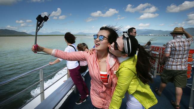 Valuable ... Chinese tourists Caroline Ou and Pang Ting Ting take selfies on the boat trip to Green Island off Cairns. Picture: Luke Marsden/News Corp Australia