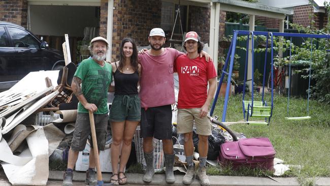 Cécile Dehant (second from left) outside her Mullumbimby home with friends Lalo, Mathieu Carlot and Jonathan Richer, who were helping with the clean-up. Picture: Liana Boss