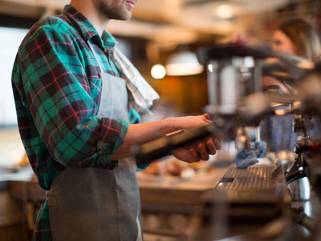 Side view midsection of man working in coffee shop
