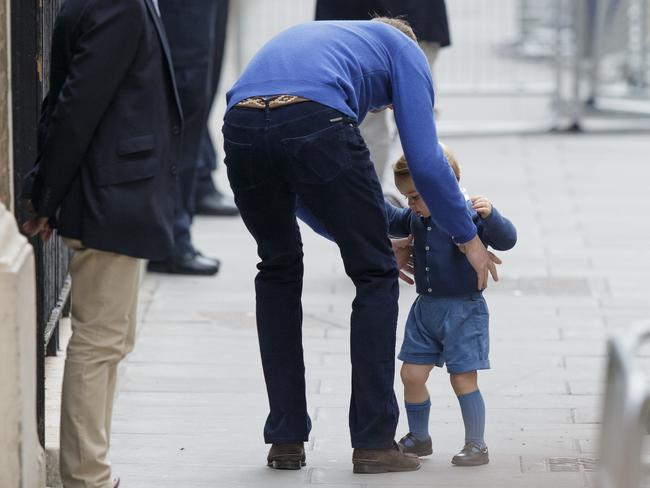 Prince William picks up his son, Prince George as they arrive at the Lindo Wing at St. Mary's Hospital following the birth of the royal baby, London, Saturday, May 2, 2015. (AP Photo/Tim Ireland)
