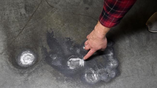 Mr John points out another defect, inadequate waterproofing in the carpark. Picture: Nicki Connolly/news.com.au