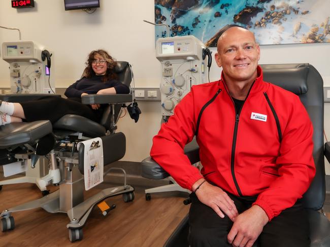 Michael Klim at the Lifeblood Brunswick Donor Centre. Klim suffers from the chronic inflammatory demyelinating polyneuropathy (CIDP) and relies on plasma donors to treat his condition. Plasma donor Beth Paterson is in the background. Picture: Ian Currie