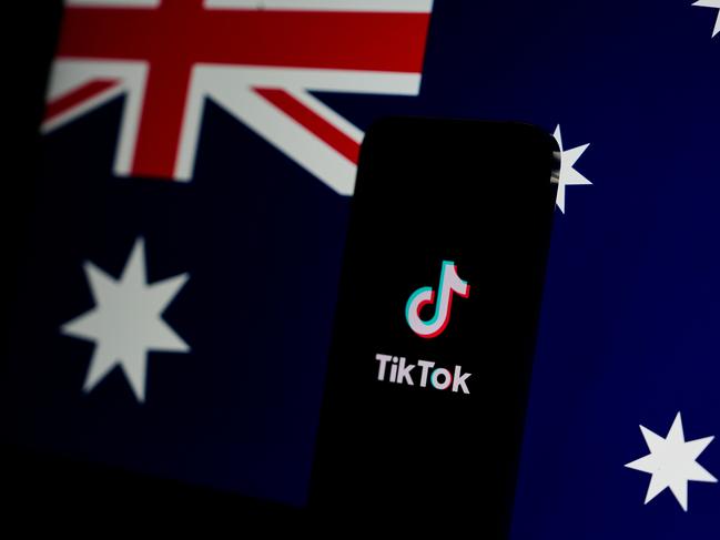 MELBOURNE, AUSTRALIA - NOVEMBER 30: In this photo illustration, the TikTok app is open on a phone with the Australian flag displayed in the background on November 30, 2024 in Melbourne, Australia. Australia has recently enacted a groundbreaking law prohibiting individuals under the age of 16 from accessing social media platforms, marking one of the strictest regulations of its kind globally. This legislation, which holds social media companies accountable for enforcing the ban with potential fines of up to AUD 50 million, aims to protect young users from online dangers such as bullying and exploitation, reflecting a significant shift in how governments address youth safety in the digital age. (Photo Illustration by Asanka Ratnayake/Getty Images)