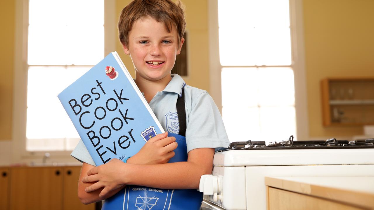 Tottenham Central School year 5 student Harry Chase, 10, with the ‘Best Cook Book Ever — Probably’. Picture: Jonathan Ng