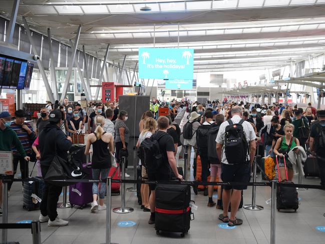 Lines of passengers trying to depart Sydney Airport in Sydney on Friday. Picture: AAP