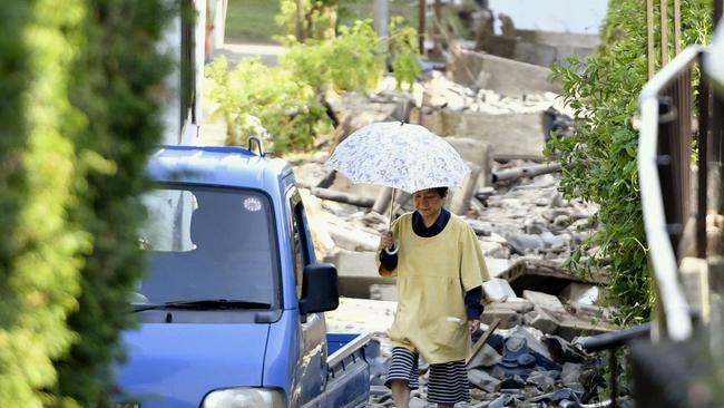 A resident walks through the debris after a 7.0 earthquake hit southern Japan. Picture: Kyodo News.