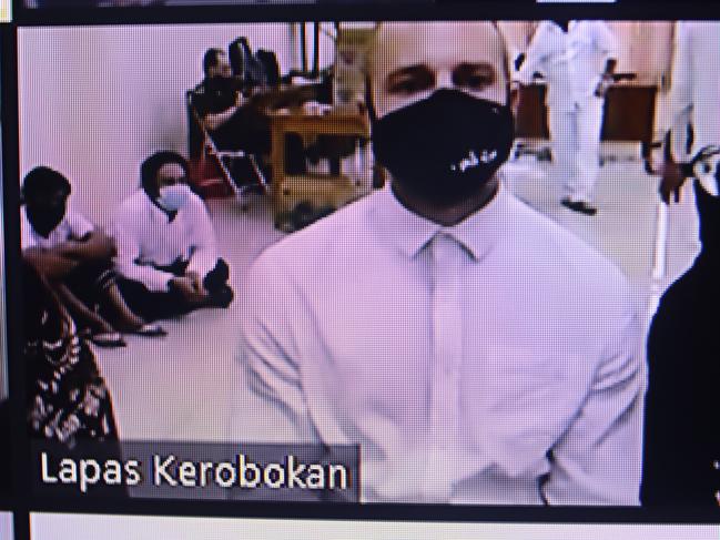 Jed Texas,(with black mask) during an earlier hearing in his virtual trial from inside Kerobokan Jail, in Bali. Picture. Lukman S. Bintoro