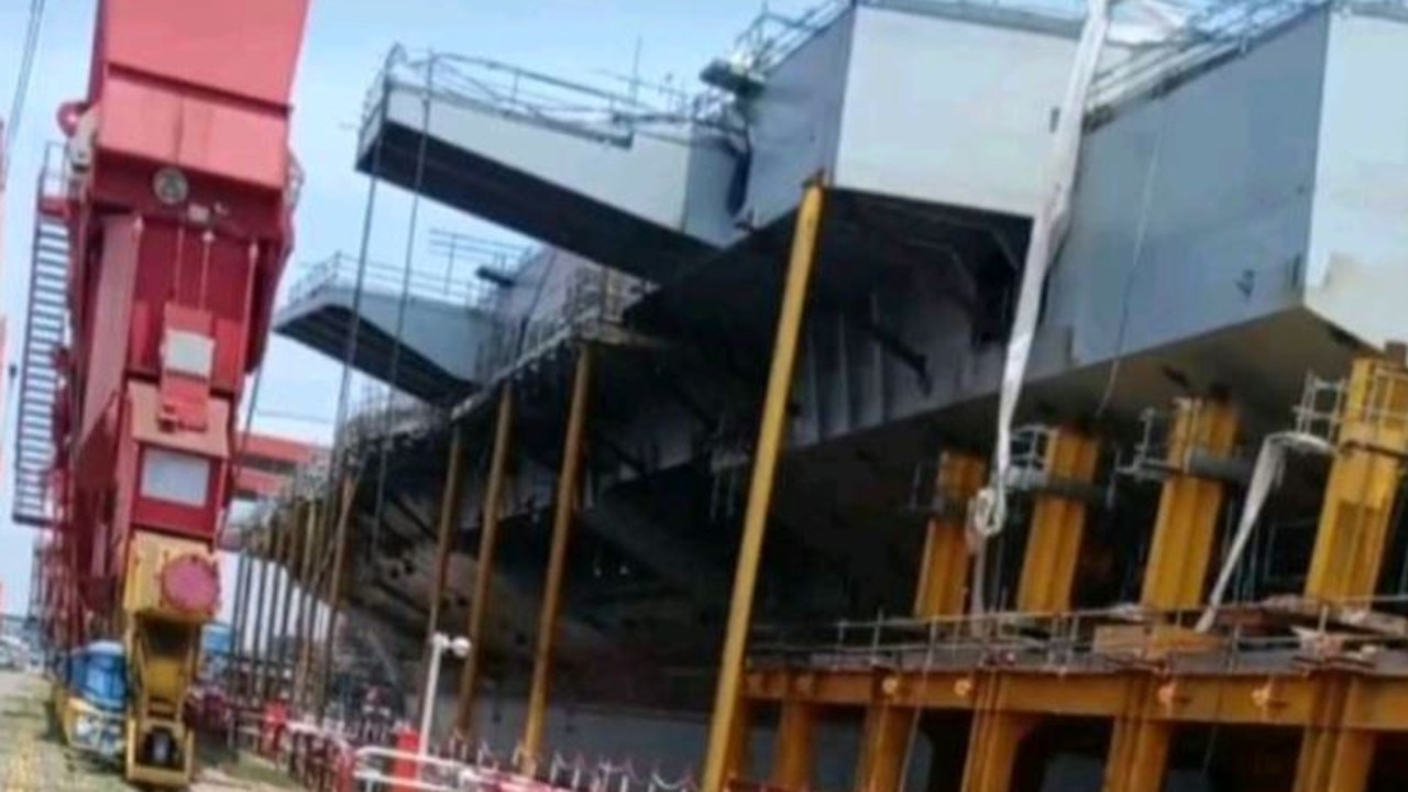 This photo, removed shortly after it was uploaded to TikTok, reveals the stern-port (back left) quarter of the Type 003 currently under construction in China. Visible is the large overhang of the angled flight-deck and sponsons (extensions) that will likely carry landing aids and defensive equipment. Picture: TikTok