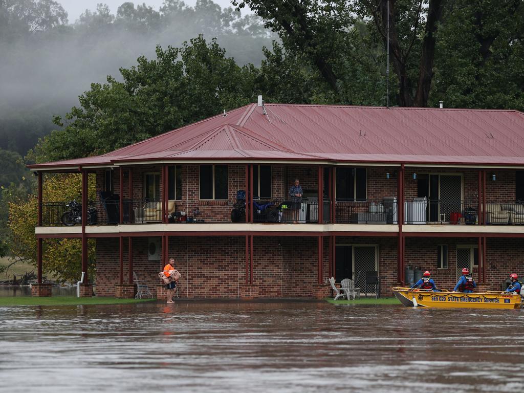 A State Emergency Service rescue crew evacuates a person by boat after rising floodwaters trapped residents, as the state of New South Wales experiences widespread flooding and severe weather, in western Sydney. Picture: Reuters