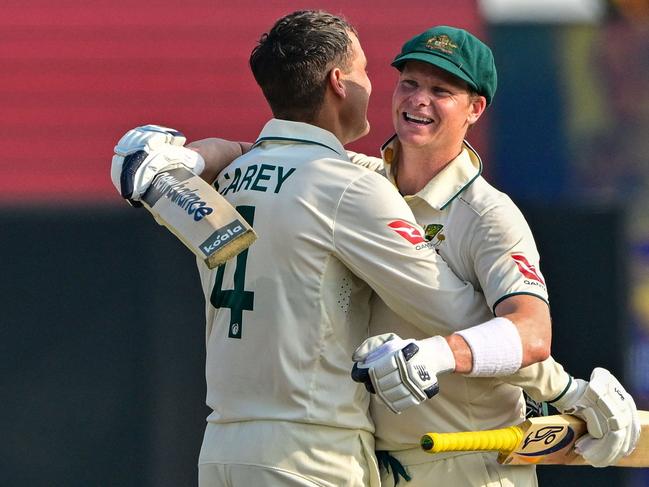 TOPSHOT - Australia's Alex Carey (L) celebrates with his captain Steve Smith after scoring a century (100 runs) during the second day of the second Test cricket match between Sri Lanka and Australia at the Galle International Cricket Stadium in Galle on February 7, 2025. (Photo by Ishara S. KODIKARA / AFP)