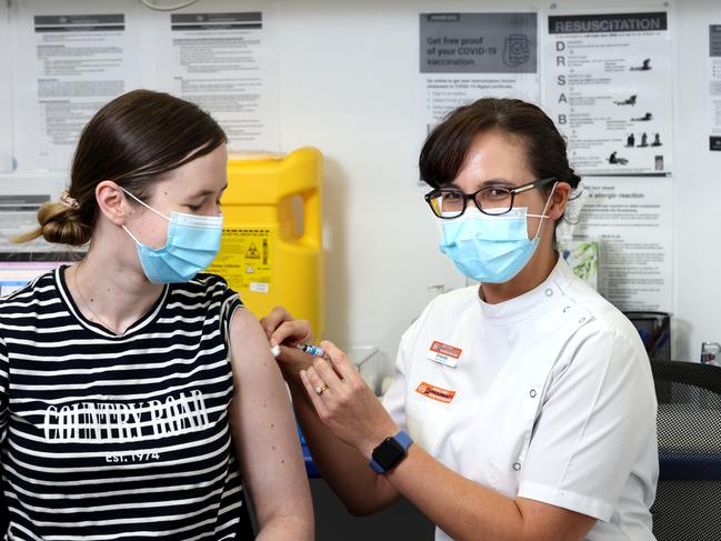 Courtney Mawn from Coorparoo getting a flu jab from pharmacist Amanda Seeto. Picture: Steve Pohlner