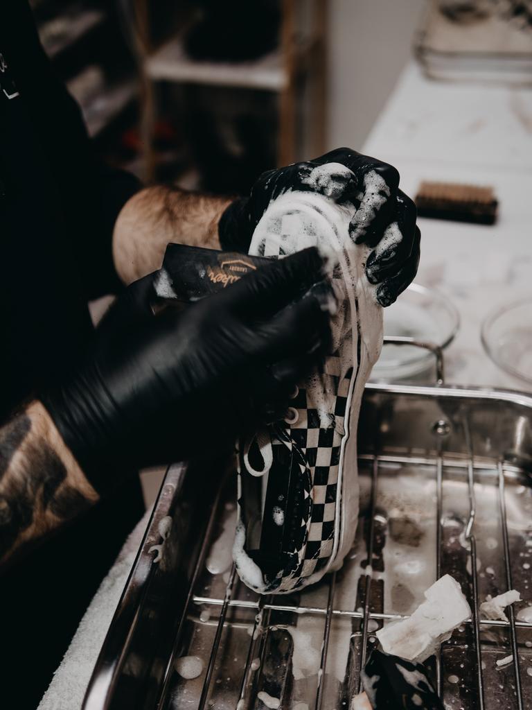 A pair of Vans being cleaned at the Melbourne store.