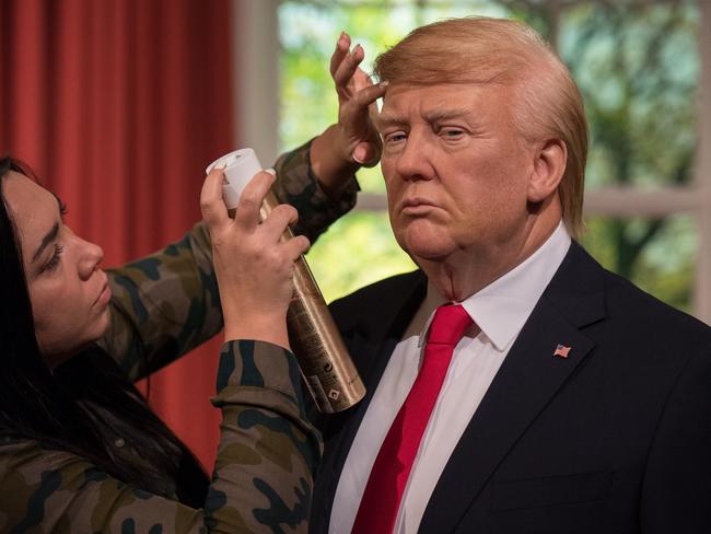 Hair stylist Gemma Sim puts finishing touches in place as Madame Tussauds unveils a wax figure of Donald Trump in January 2017. Picture: Getty