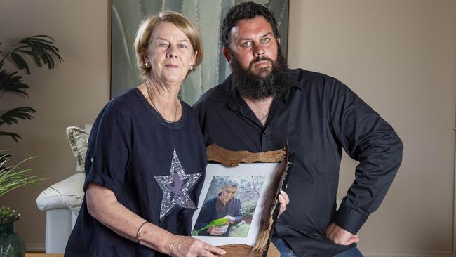 Barb Spriggs and her son Clive hold a portrait of her husband Bob after the release of the Aged Care Royal Commission report. Picture: Brenton Edwards