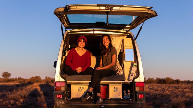 French tourists Alice Ripoll, 25, and Marine Abecassis, 27, wait in their campervan near the South Australia/Northern Territory border. Picture: Emma Murray