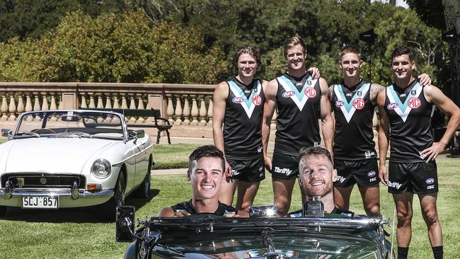 Port Adelaide players after the club announced a five-year sponsorship deal with car dealer MG.. Connor Rozee and Robbie Gray in a historic MGC with Xavier Duursma, Tom Jonas, Hamish Hartlett and Tom Rockliff in the background. Picture SARAH REED