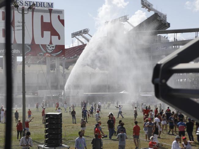 Tampa Fire Rescue sprayed water to cool off Trump supporters during his campaign speech. Picture: AFP