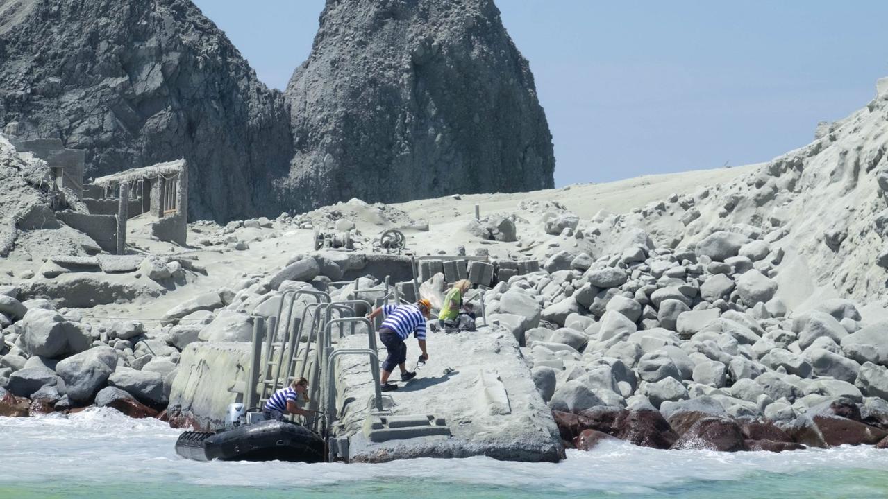 White Island Tour operators rescuing people. This photo was taken at 2.24pm, 13 minutes after the eruption. Picture: Michael Shade/Twitter