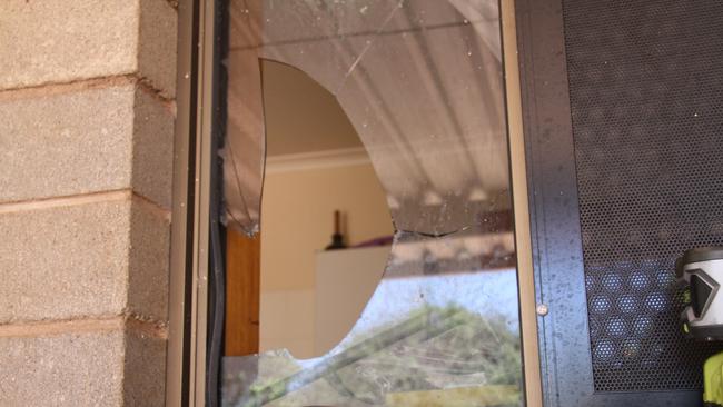 A broken window at a home on Hibiscus St, Eastside, Alice Springs, Wednesday December 19, 2024. In the home lives 87-year-old Margaret Moore, who has Alzheimer's, and her carer Meloni Lambert, who say they were broken into again the day before. It marks the fifth time in two years Mrs Moore's home has been broken into. Picture: Gera Kazakov