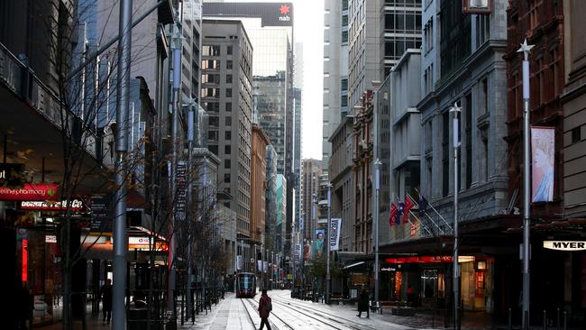 A pedestrian moves along an almost empty George Street in the CBD on June 28, 2021 in Sydney, Australia. Picture: Getty