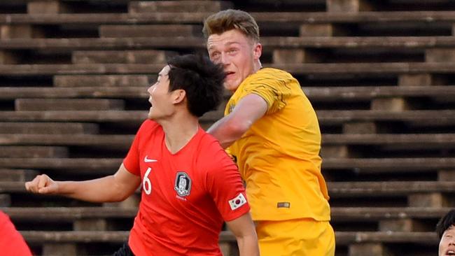 Olyroos defender Harry Souttar (right) jumps for a header with South Korea's Kim Dong-hyun during their match on Tuesday night. Picture: AFP 