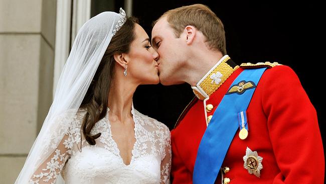 The first kiss! Kate and William on the balcony of Buckingham Palace. Picture: AFP