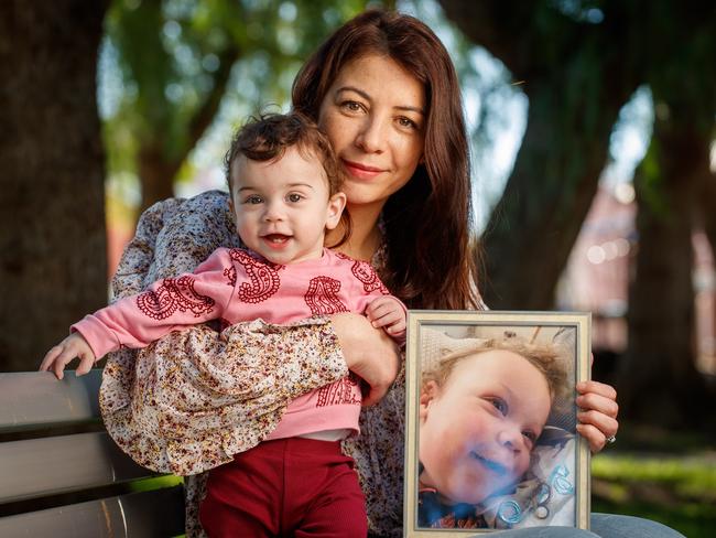 Anna Pak Poy with daughter Layla 11 months and a picture of her beloved son Sebby, who sadly passed away last year. Picture Matt Turner