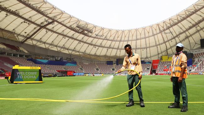 Groundsman make final preparations to the stadium.