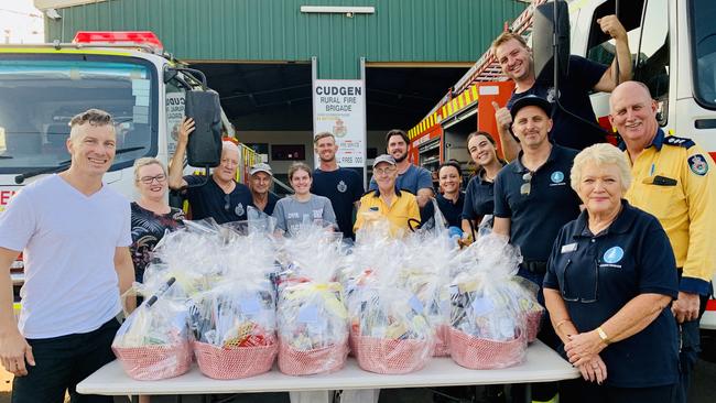 Kingscliff and District Chamber of Commerce president James Owen joins Cudgen Rural Fire Service volunteers at the presentation of hampers to them as a way of saying 'thank you' for their tireless efforts in fighting fires on the Northern Rivers. Photo: SUPPLIED