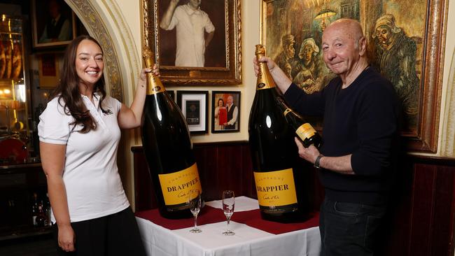 Rhiahne Ralph and Marcello Marcobello with the giant bottles of champagne. Picture: Rohan Kelly