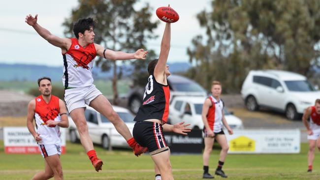 Flaggies’ Ryan Mountford flies behind Christies Beach’s Emmerson White. Picture: AAP/Brenton Edwards