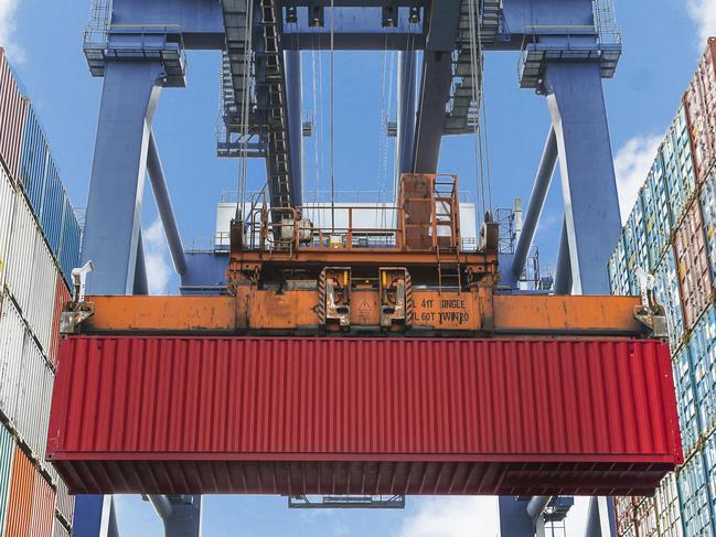 Shore crane lifts container during cargo operation in port