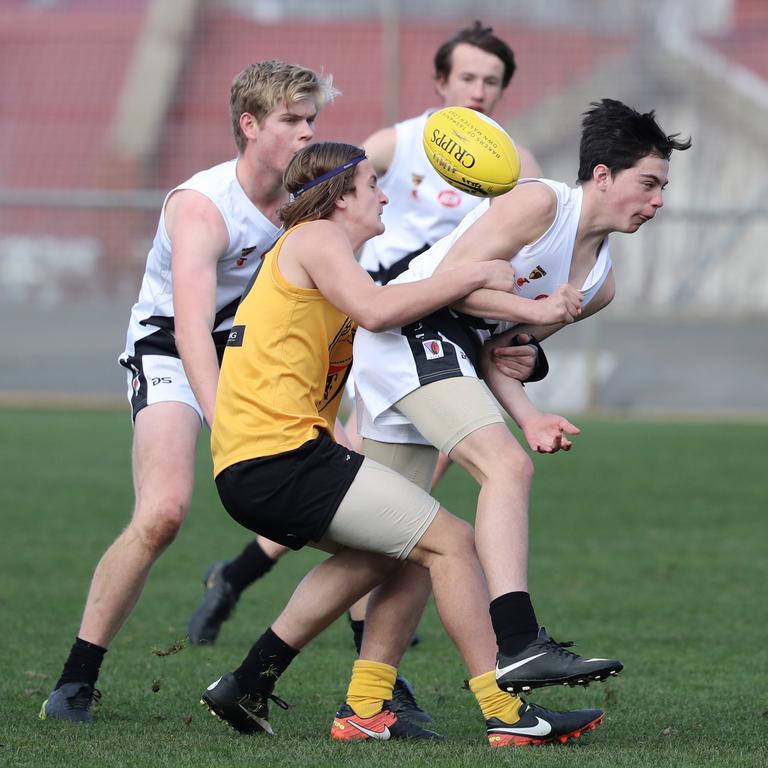 Under 16 Boys STJFL vs. NTJFA match, North Hobart Oval: South's Jacob Whitney (left) tackles North's Sabyn Harris. Picture: LUKE BOWDEN