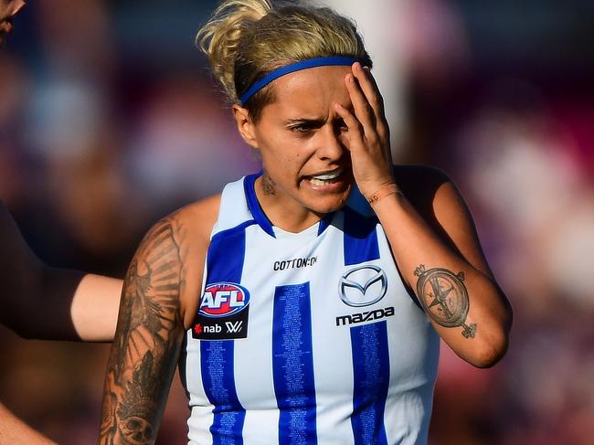 FREMANTLE, AUSTRALIA - MARCH 17: Moana Hope of the Kangaroos nurses her eye after a hit during the 2019 NAB AFLW Round 07 match between the Fremantle Dockers and the North Melbourne Kangaroos at Fremantle Oval on March 17, 2019 in Fremantle, Australia. (Photo by Daniel Carson/AFL Media)