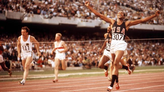 Tommie Smith wins gold in the 200m at the 1968 Olympics in Mexico City. Picture: Getty Images