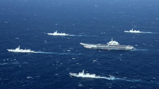 A Chinese navy formation, including the aircraft carrier Liaoning, centre, during drills in the South China Sea in 2017. Picture: AFP